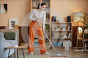 Girl Wearing Headphones And Mopping Floors