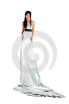 Girl wearing long silver dress looks mysteriously photo