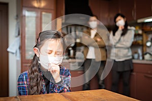 Girl wearing a mask and painfully coughing