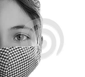 Girl wearing medical face mask on light background, closeup. Black and white photography