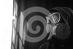 The girl is wearing a military gas mask. Isolated on a black background. Respiratory protection against harmful toxic substances,