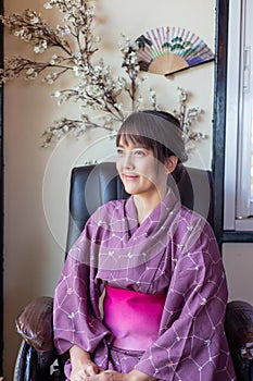 The girl is wearing a pink traditional yukata, which is the national dress