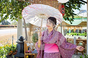 The girl is wearing a pink traditional yukata, which is the national dress of Japan