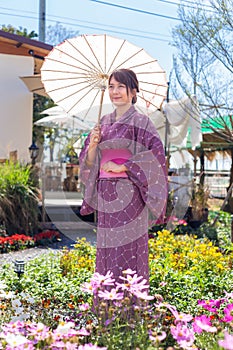 The girl is wearing a pink traditional yukata, which is the national dress of Japan