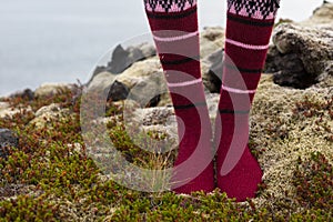 Girl wearing red Icelandic wool socks standing in.