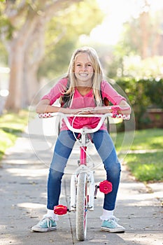 Girl Wearing Rucksack Cycling To School