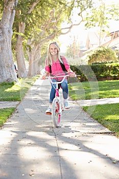 Girl Wearing Rucksack Cycling To School