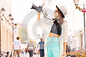 Girl wearing sunglasses shooting with camera