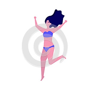 Girl wearing swimsuit jumping on beach. Summer vacation concept.