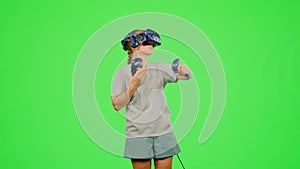 The girl wearing VR headset in virtual reality. The woman moves activity immersive experience. Chroma key green screen