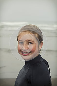 Girl wearing wet suit on Rockaway beach Oregon