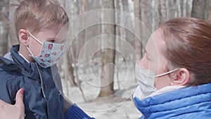 The girl wears a protective mask to her child. Prevention and protection of health and life safety. pandemic in the