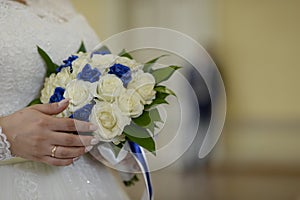 a girl in a wedding dress holds the bride's wedding bouquet photo