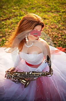 Girl in a wedding dress with with saxophone