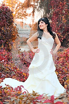 Girl in a weeding dress in a park