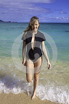 Girl in wetsuit at the beach