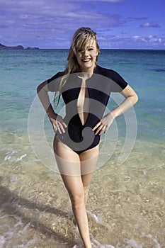 Girl in wetsuit at the beach