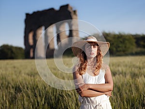 Girl in wheat field, backlight