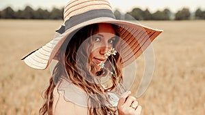 Girl wheat field summer. Happy young woman in sun hat in summer wheat field at sunset. Nature, summer holidays, vacation