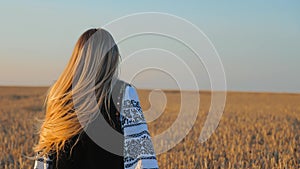 a girl in a wheat field in Ukrainian national dress. A walk in the field at sunset