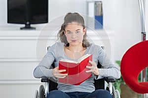 Girl in wheelchair reading book