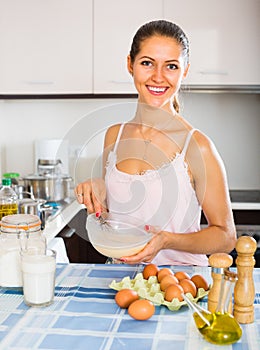 Girl whisking eggs for omelette