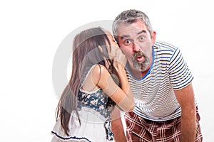 Girl whispering in dad's ear