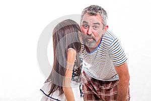 Girl whispering in dad's ear