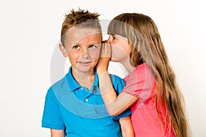 Girl whispering to boy