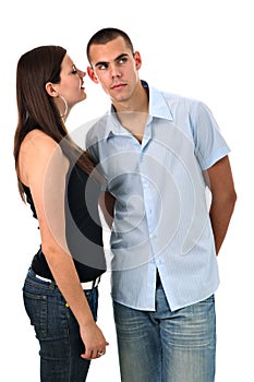 Girl whispers into her boyfriend's ear isolated