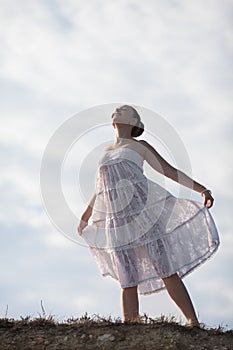 Girl in white on background of sky