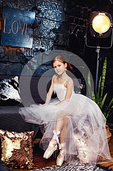 Girl in a white ball gown and shoes, beautiful red hair. Young t