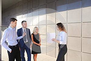 Girl in white blouse holds paper and explains, makes remarks, ex