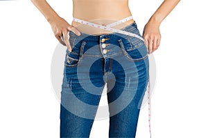 Girl on white in blue jeans and tape measure.