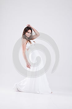 Girl in white clothes in a dance pose.