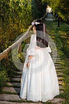 Girl with the white communion or Latin quinceaÃÂ±ero dress, with her back turned photo