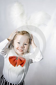 Girl in a white downy bunny costume. photo