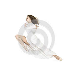A girl in a white dress dancing ballet