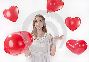 Girl in white dress with heart-shaped baloons