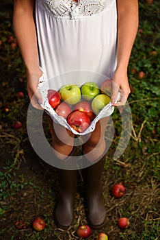 Girl with white dress hold apples