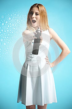 girl in a white dress holding a bottle with hairspray photo