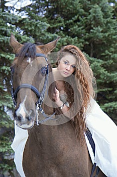 Girl in a white dress on a horse