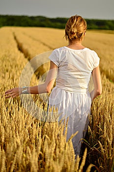 Girl in white dress in the wheat field
