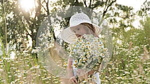 girl in a white dress and white hat with a bouquet of daisies