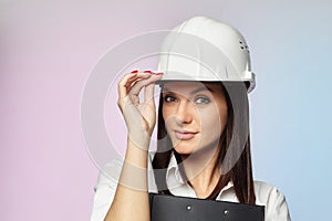 The girl in the white helmet points the direction with her hand. the concept of a businesswoman who understands construction,