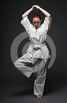 Girl in white kimono, traditional stance of aikido photo