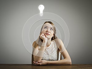 Girl in white and light bulb