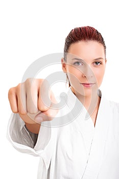 Girl in white martial arts kimono punching the camera