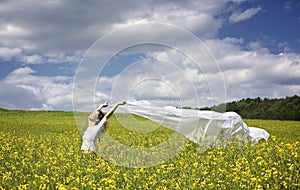 Girl with white piece of cloth in wind