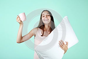 Girl with white pillow and cup